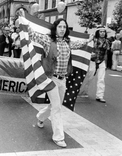 Parade participants carrying a "Gay American Indians" banner