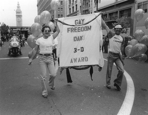 Participants displaying "Gay Freedom Day 3-D Award" banner