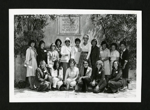 Scripps alumnae from the class of 1956 smiling together in Margaret Fowler Garden, Scripps College