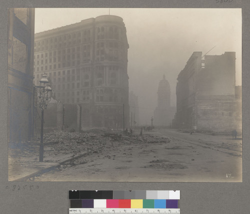 [Market Street littered with debris. Flood Building, center; Call Building in distance, right center.]