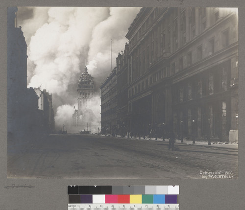 [Market Street, looking northeast toward burning Call Building from near Powell St. Emporium department store at right.]