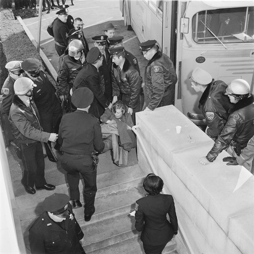 Arrested students being loaded into sherriff's bus before being taken to jail