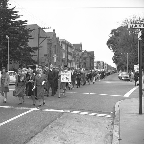 Women pushing their kids in strollers in the protest march down Oak street towards the Federal Building