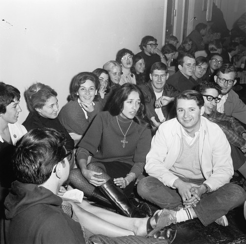 Joan Baez sitting in Sproul Hall with other demonstrators