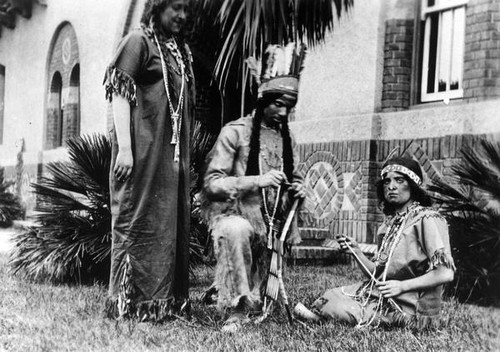 Three people in Native American dress