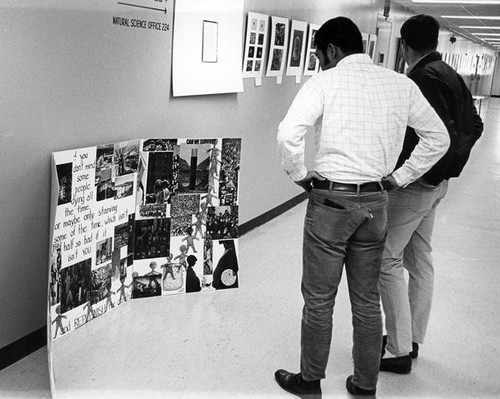 San Jose State College students looking at a poster board