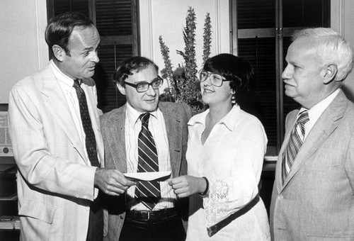 John Bunzel handing over an envelope