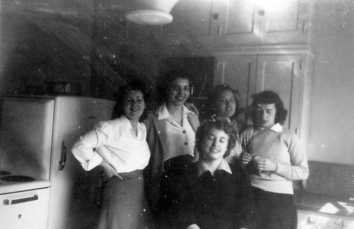 Students posing for photograph in a kitchen