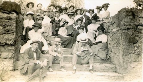 Faculty members sitting on stone steps