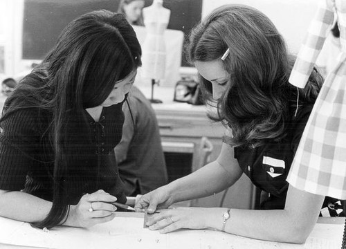 Two female students measuring