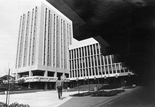 Man walking towards the School of Business buildings