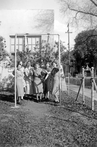 Home economic students sitting on a swing