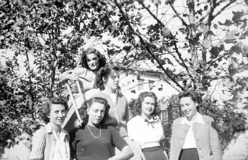 Home Economic students, one sitting on a children's slide