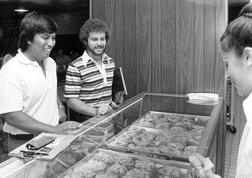 San Jose State College students looking at donuts