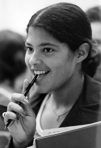 Student with pen on mouth