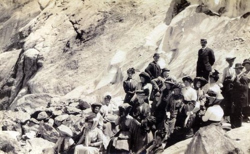 Faculty members sitting on rocks