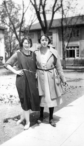 Two females in front of the library