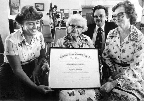 Bessie Wyman displaying diploma