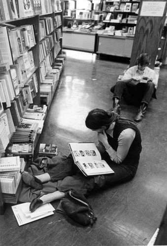 San Jose State College students reading in the bookstore