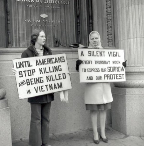 Women holding protest signs against Vietnam War