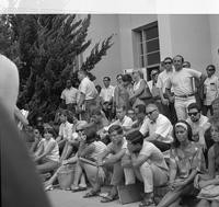 Students gather on steps of building