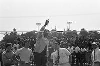 Track officials measure high jump pole