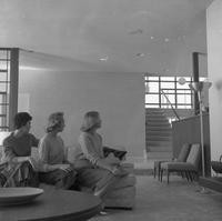 Three women posing on a couch