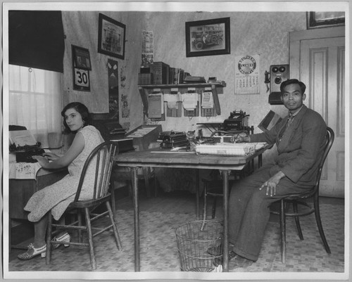 2 employees at desks in an office [ca. 1935]