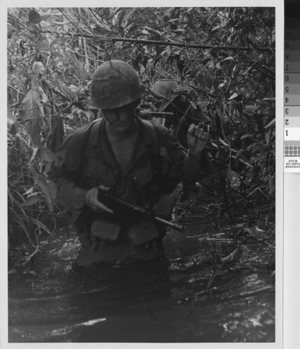 Soldiers on patrol up a stream - Vietnam