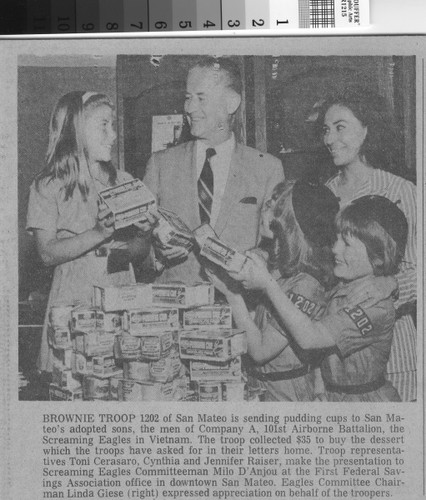 San Mateo Times photo as published of Brownie Troop 1202 presenting the pudding cups they purchased