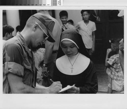 Soldier presenting gift to orphanage 7/18/69 - Vietnam