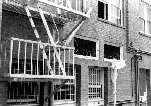 View of the fire escape on the alley wall (facing Presbyterian Church) of the Santa Ana Hotel, during demolition in 1987