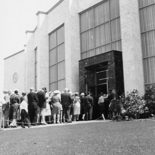 Crowd entering front door of Santa Ana Public Library at 26 Civic Center Plaza for the dedication ceremonies on May 1, 1960