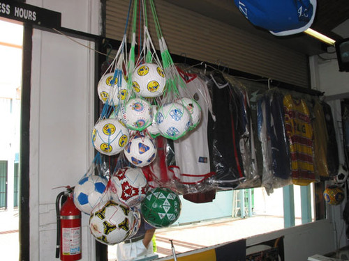 Soccer balls and merchandise hanging in a shop at El Faisan on Fourth Street, August 2002
