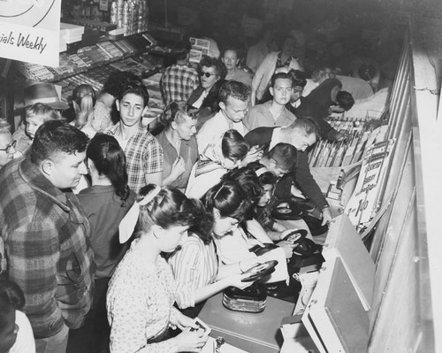 Crowd of shoppers in the record section of a department store — Calisphere