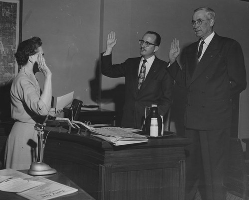 Dale Heinly, center, and J. Ogden Markel being sworn in to service in Santa Ana city government