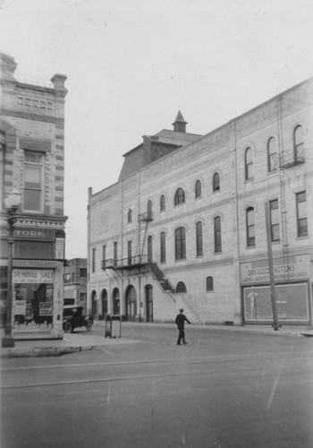 View of the Grand Opera House on 203 E. 4th St., corner of Bush and Fourth St. with the Opera House on the N. E. corner, about 1930