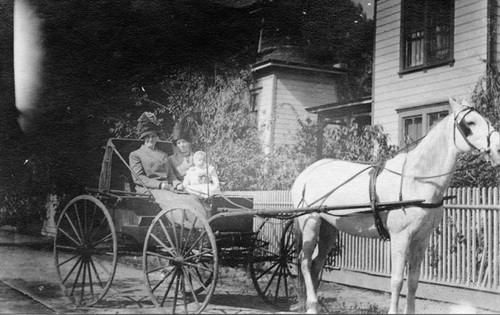 Agnes McNeal and Irene Noble in a buggy pulled by a horse named Polly in front of 1020 N. Baker