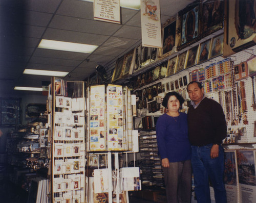 Sam Romero in his shop, St. Teresa's Gifts, at 300 E. 4th Street with Mrs. Romero