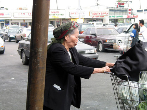 Elderly female shopper on the corner of Bolsa and Magnolia