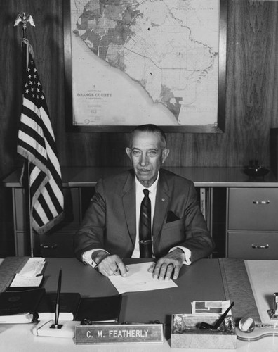 C. M. Featherly in his office