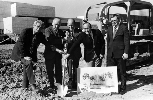 Group at groundbreaking with architect's sketch of the State of California office building