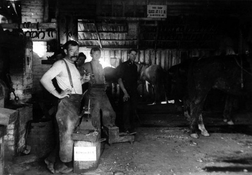 Fine's Blacksmith Shop on the N.E. corner of 5th and Broadway in 1914