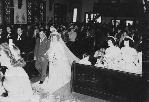 Lupe Ruiz and her father coming down the aisle on her wedding day