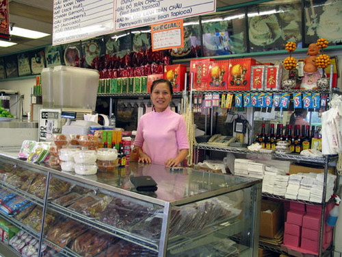 Store clerk and merchandise at a Vietnamese shop, Van's Bakery, in the Asian Village center