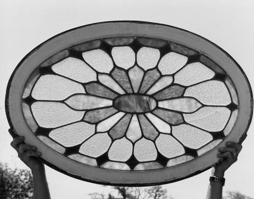 Stained glass "rose" window (concave) from the main stair well of the Dr. J. A. Hatch house about 1981