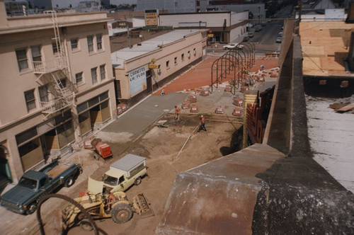 Construction vehicles and pallets of bricks near the Hotel Corday on Spurgeon Street