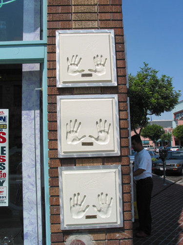 Handprints of famous artist on the Ritmo Latino music store on the corner of Fourth Street and French Street, August 2002