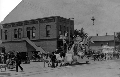 Treseau Mullinix (Mrs. Verne Whitson) on float as queen of parade, Main Street, downtown Santa Ana