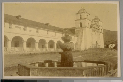 Old Mission Church. It is 160 feet long by sixty in width - its walls are eighty feet in thickness. The height the nave is forty feet. On the wall to the right hangs a picture representing a king and a monk up to their middle in the flames of purgatory. On the other side is a picture of hell. Immediately before the altar is a trapdoor opening into the vaults where are buried the missionary padres. Over the altar are many rich images of the saints. Three silver candlesticks five feet high and a silver crucifix of the same height with a golden image of the Savior suspended on it stand within the church. A door in the eastern wall leads to the cemetery